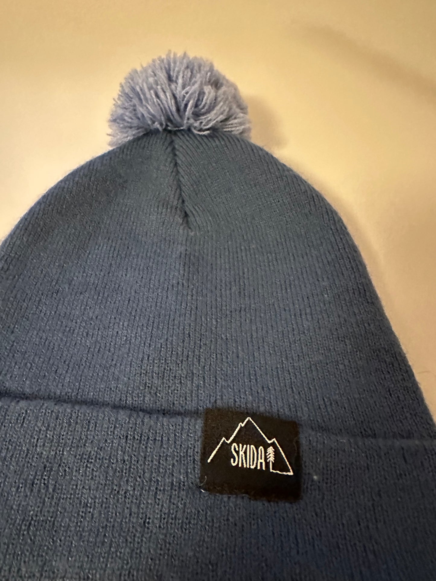 Skida Firetower Pom Beanie Hat in Blue